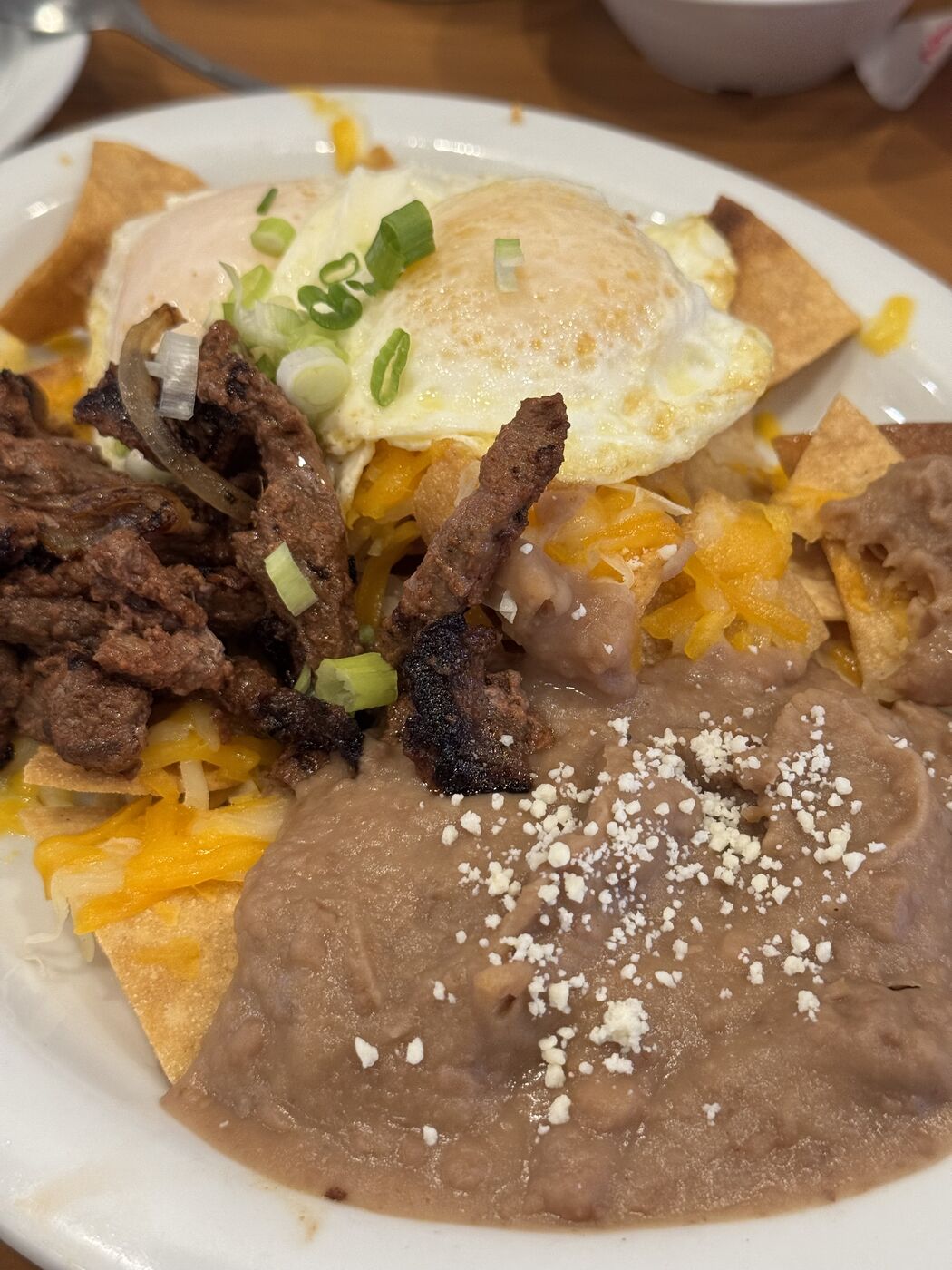 Breakfast plate of carne asada, eggs, beans, and cheese at Loaded Cafe in Los Angeles